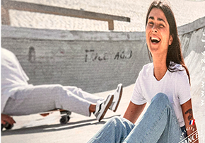 visuel imprimé sur présentoir carton, jeune femme souriante en skatepark avec chaussures S.24, ambiance urbaine et lifestyle